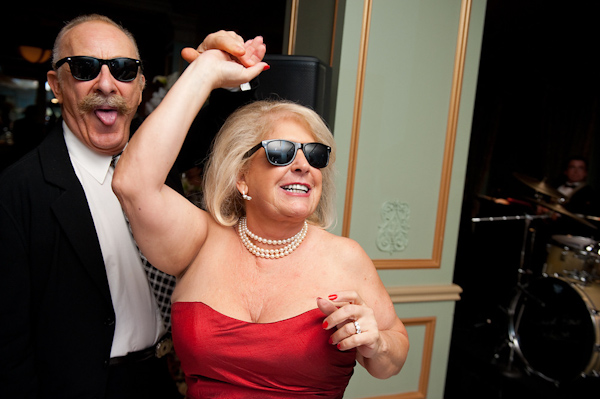 hillarious photo of the parents wearing sunglasses and dancing at the reception - photo by Houston based wedding photographer Adam Nyholt